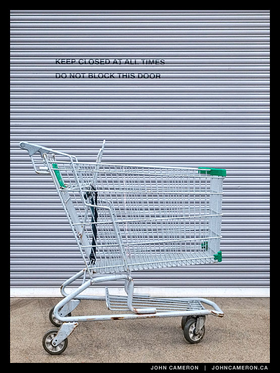 A shopping cart blocks the door.